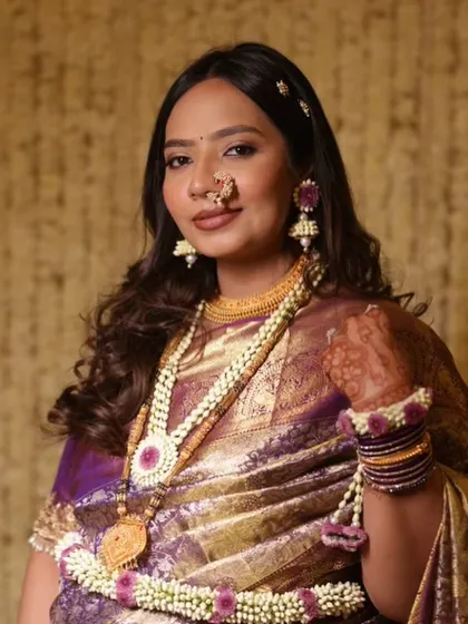 Glowing and gorgeous for her baby shower. This traditional look with a beautiful Paithani saree and floral jewelry is perfect for celebrating the little one on the way.