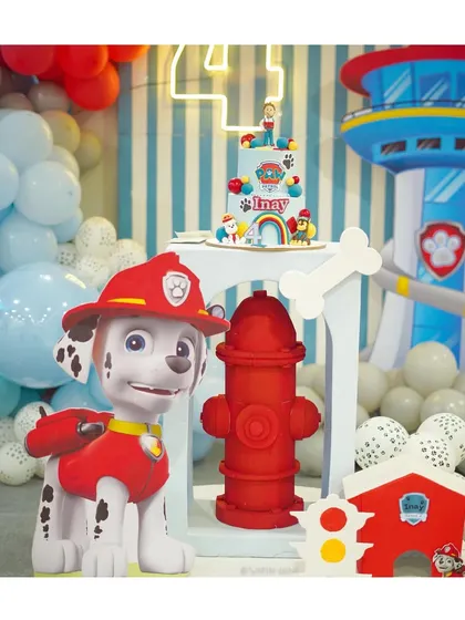 Marshall is all fired up for this Paw Patrol party. The setup includes a life-sized Marshall prop, a fire hydrant, and the iconic Lookout Tower in the background.