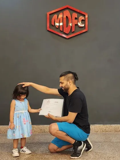 A gentle moment of encouragement while presenting a certificate on International Dance Day.