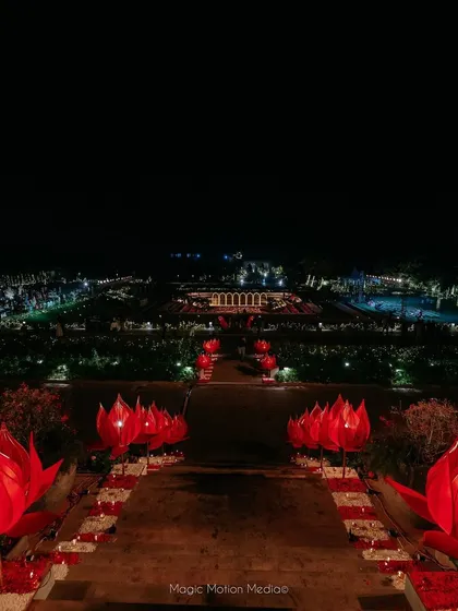 The view from the top of the stairs, looking down the aisle of red lotus lights towards the sprawling venue.