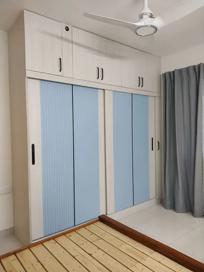 Another view of the sliding door wardrobe, showing how it fits seamlessly into the room next to the bed.