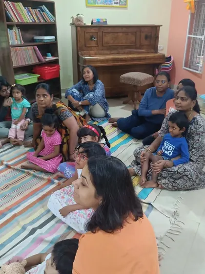 Parents listen in from the sides, enjoying the story just as much as the children.