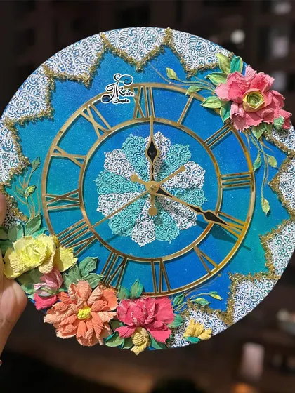 The full 14-inch ocean-themed clock, featuring warm-toned flowers that pop against the cool blue background.