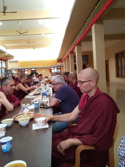 A candid moment of our teachers and community members sharing a meal together at the monastery. These informal gatherings are a cherished part of our spiritual journey, fostering connection and dialogue.
