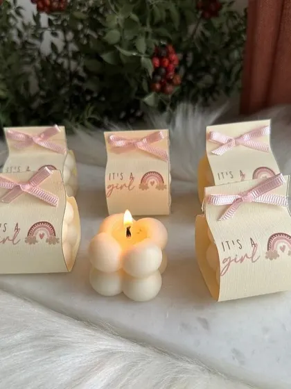 An adorable "It's a Girl" announcement gift, featuring a mini bubble candle in a custom-printed box. These are a sweet and budget-friendly way to share your joy.