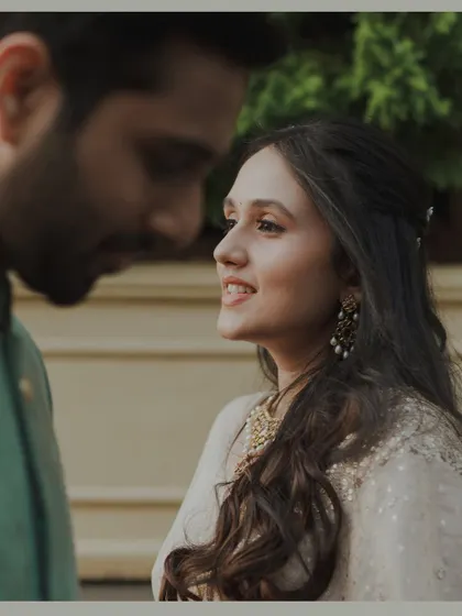 A close-up shot focusing on the bride's radiant smile as she looks at her partner. This frame captures the genuine adoration and happiness in a simple, beautiful way.