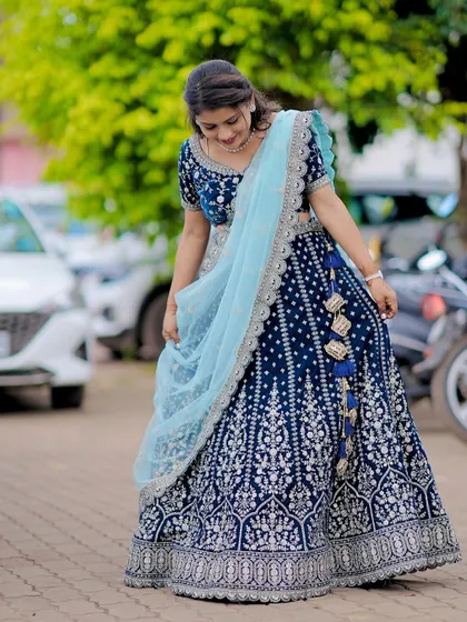 A candid moment showing the beautiful drape and flow of the custom navy blue lehenga.