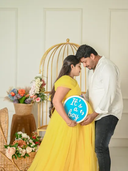 A tender moment during a gender reveal maternity shoot. The couple's gentle embrace shows their shared excitement and love.