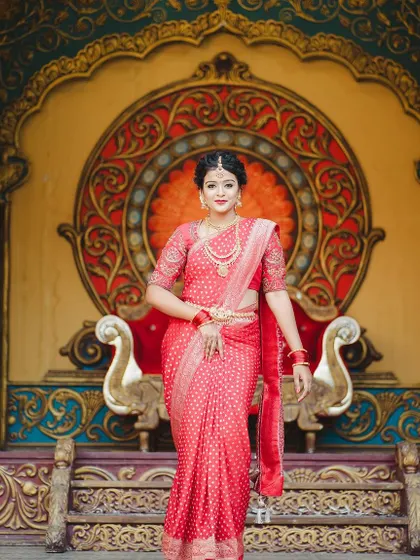 This stunning portrait captures the grandeur of the outfit against a majestic, traditional backdrop.