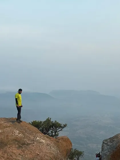 A lone trekker contemplates the view, showcasing the peace and perspective that our outdoor adventures provide.