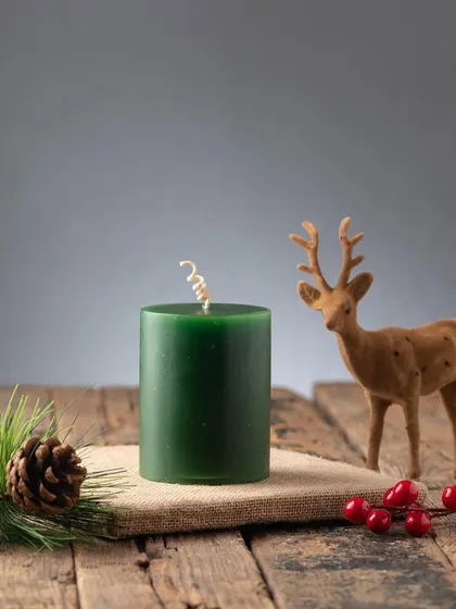 A deep green pillar candle, another versatile classic for the holiday season.