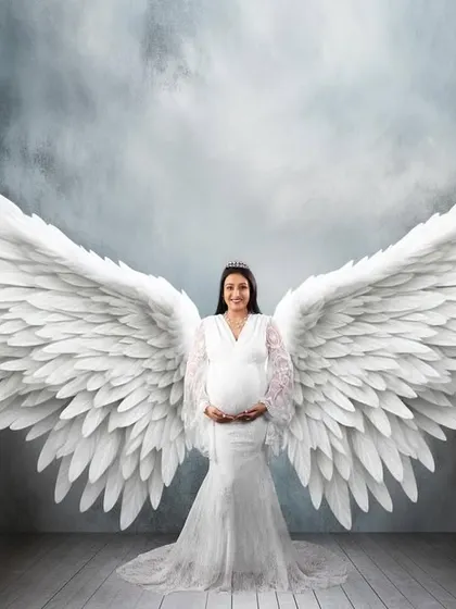 For a truly magical memory, I create fine art portraits like this one. With beautiful angel wings and dramatic lighting, I can turn your maternity photo into a breathtaking piece of art that feels truly special.