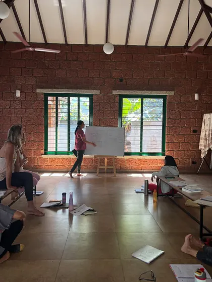 Another student takes the lead at the whiteboard. This practice of teaching helps to connect the dots between different concepts and deepens personal understanding.