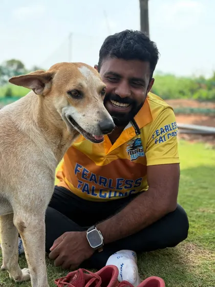 Wherever I go, dogs find me. Making a new friend at a cricket match.