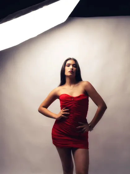 This shot shows the model adjusting her pose between takes. These unscripted moments are a key part of my BTS videography, revealing the small adjustments that lead to the perfect final photograph.