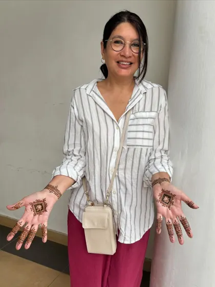 The client happily displaying her simple and elegant first henna designs.