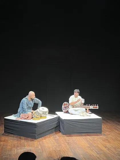 A wide shot of the stage at Prithvi Theatre. The minimalist setup is designed for a pure, acoustic experience with no microphones, allowing the natural sound of the instruments to fill the space.
