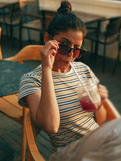 A playful, quirky shot peering over my sunglasses, showing personality and humor.