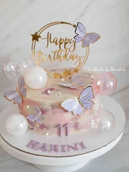 A pretty no-fondant cake decorated with lavender butterflies and translucent bubbles. The soft watercolor buttercream effect makes this a dreamy and delicate choice for a birthday.