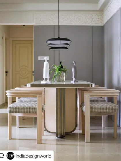 The elegant dining area of the 'YBJ Residence', featured in India Design World. The marble-topped table and modern chairs create a sophisticated space for entertaining.
