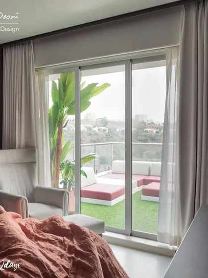 The view from the master bedroom of "Project 22 Days," looking out onto the terrace. The sliding glass doors create a seamless transition between the indoor and outdoor spaces.