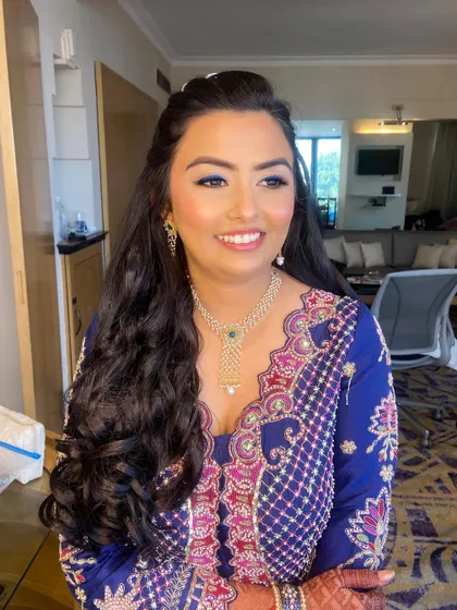 The pop of blue on the eyes adds a fun and unexpected element to this beautiful mehendi look.