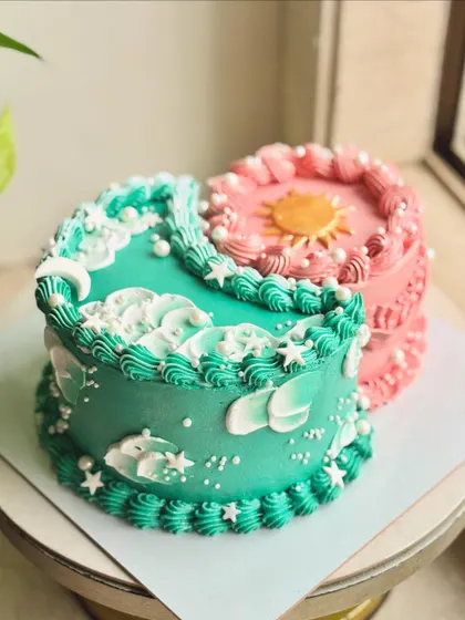 It's giving cosmic energy. This unique design features two half-cakes joined together, one representing the moon and the other the sun, each with its own flavor and color scheme.