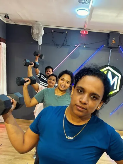 Push yourself, because no one else is going to do it for you. Our members demonstrating proper form and dedication during a dumbbell workout, building upper body and core strength.