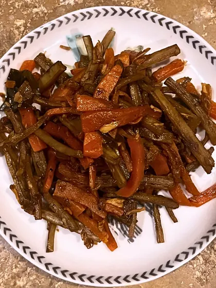 This Smoked Kharsinga and Carrot stir-fry is our salute to indigenous wild foods. We stir-fry smoked Kharshinga (a wild vegetable) with carrots and Malabar tamarind, celebrating tribal culture and sustainable foraging.