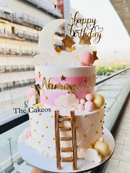 A full view of the dreamy two-tier moon and stars themed birthday cake, perfect for a magical celebration.