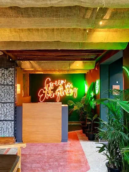 The entrance to Social Offline, with its "Green Egg & Ham" neon sign. This image serves as an inviting welcome to potential customers.