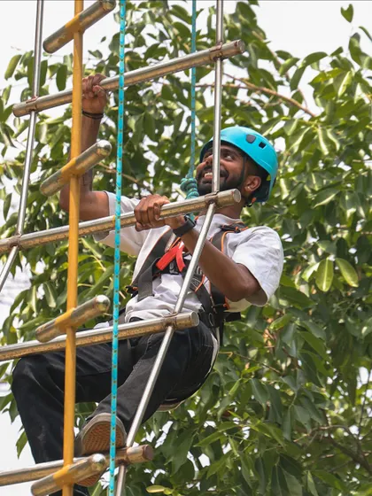 The joy of conquering a challenge is written on his face. Our rope ladder climb is a fun and demanding part of the high ropes course that tests your strength and determination.