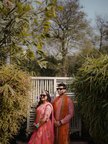 A stylish portrait of the couple during their Mehendi ceremony. Their cool sunglasses and confident pose add a modern twist to the traditional event.