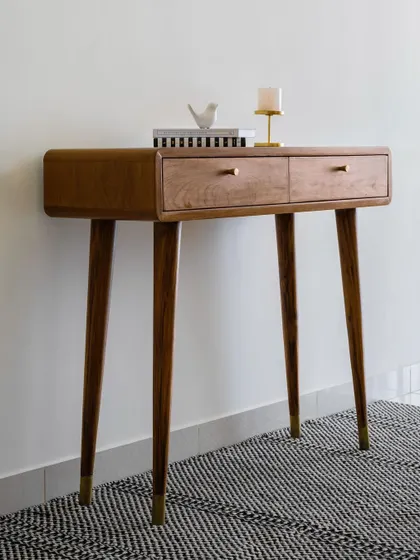 The 'Marshall' console table is perfect for an entryway or passageway. Its slender, tapered legs are adorned with brass shoes, adding a touch of elegance to its minimalist design.