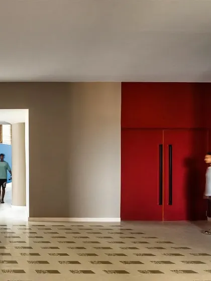 We use color to define spatial thresholds and guide circulation, as seen here in the MARC Auditorium. The contrast between neutral tones and bold primary colors creates a memorable architectural journey.