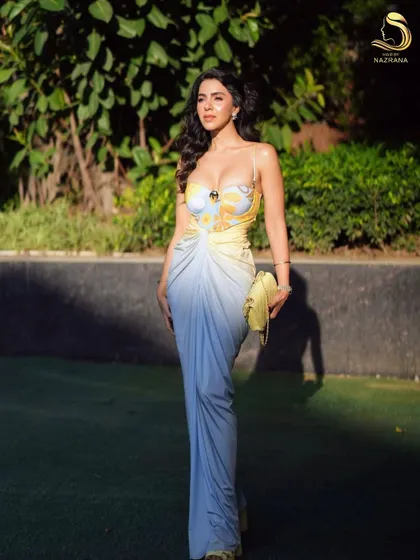 The full look, with voluminous waves that create a glamorous and confident silhouette.