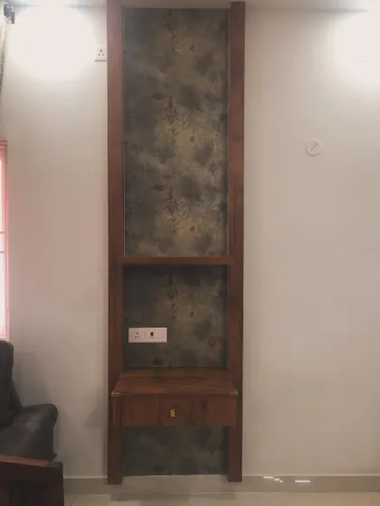Here, a textured wallpaper is used as a backing for a narrow, custom-built shelving unit.