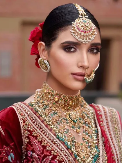 A classic red velvet bridal lehenga paired with a dramatic winged liner and bold jewelry. This is a timeless look, and I teach the techniques to make it look modern and fresh, not dated.