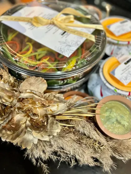 A closer look at a beautifully assembled meal platter, featuring a main dish, side dips, and decorative elements. Every detail is considered to create a visually appealing and delicious gourmet experience at home.