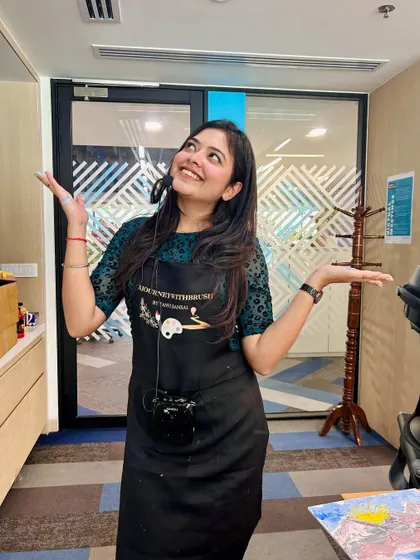 A happy, candid shot of me on Women's Day, ready to start a workshop. My goal is to help everyone paint their life with a rainbow of colors.