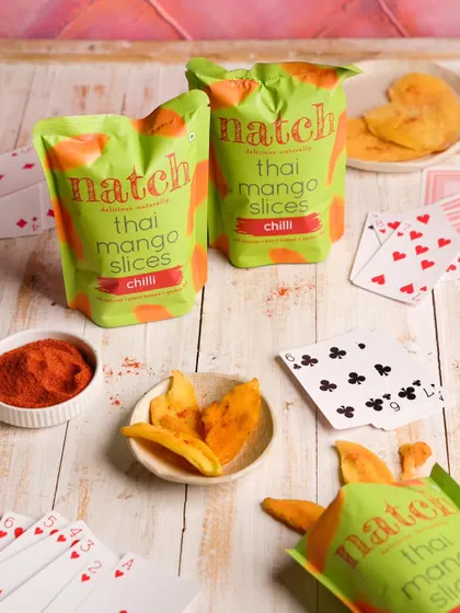 Creating a fun, playful scene for Natch's spicy mango slices, suggesting it as the perfect snack for a game night.