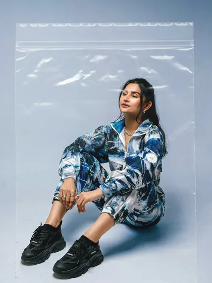 This shot from the 'Shanaya-Verse' series uses a plastic bag prop to create a unique, high-fashion look, all while demonstrating the iPhone's camera capabilities.