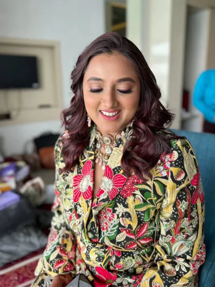 A party-ready look for a Sangeet. The makeup is designed to be vibrant and long-lasting, perfect for a night of celebration.