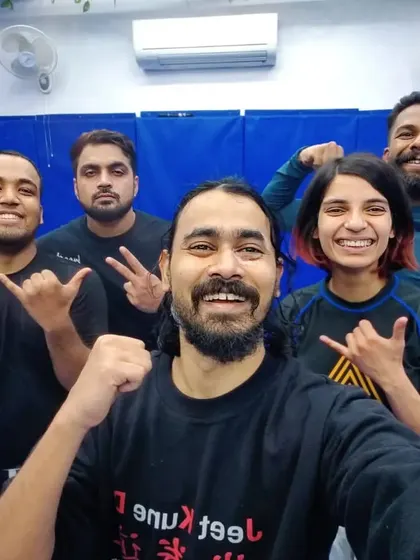 The instructor with a group of students after a session on Jeet Kune Do concepts, focusing on adaptability and real-world application.