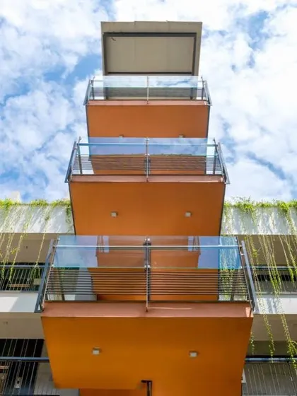 A duplicate image of the 'Poetree' balconies against a bright blue sky, highlighting the project's cheerful and modern aesthetic.