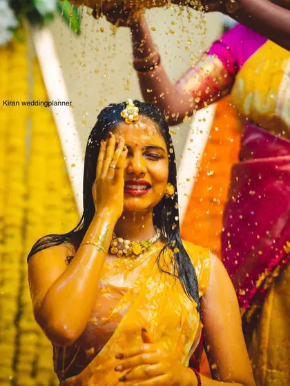 A candid moment of a bride during her Haldi ritual, capturing the emotion and beauty of the tradition.