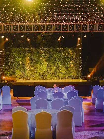 The party is on! A wide view of the outdoor sangeet venue, with a large stage, professional lighting, and seating ready for guests.