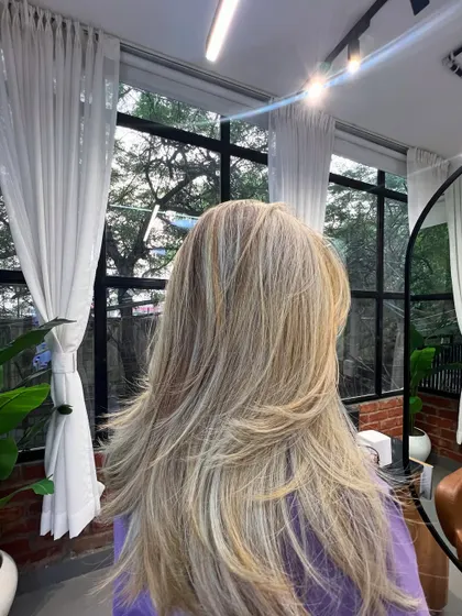 The final result of a complex color correction. The hair is now a beautiful, multi-dimensional blonde with healthy-looking layers.