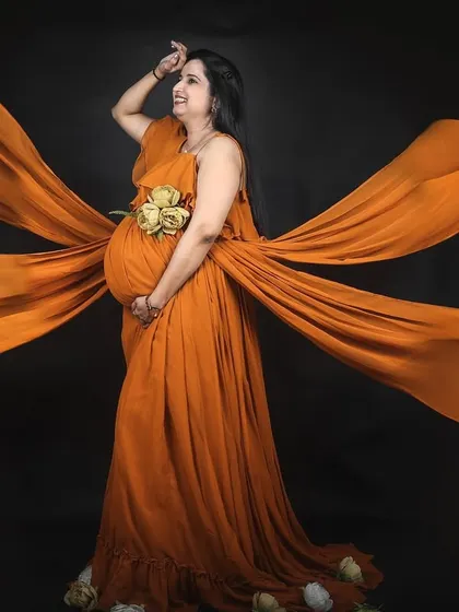 A powerful and artistic studio shot of our mustard four-trail maternity gown. The trails can be arranged in multiple ways to create dramatic and unique images.