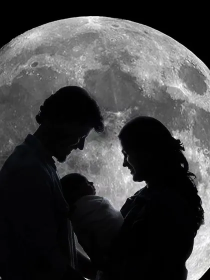 A beautiful silhouette portrait of parents and their newborn against a digitally created full moon, highlighting their new bond as a family.
